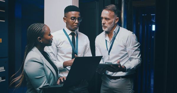 Three researchers discussing their findings